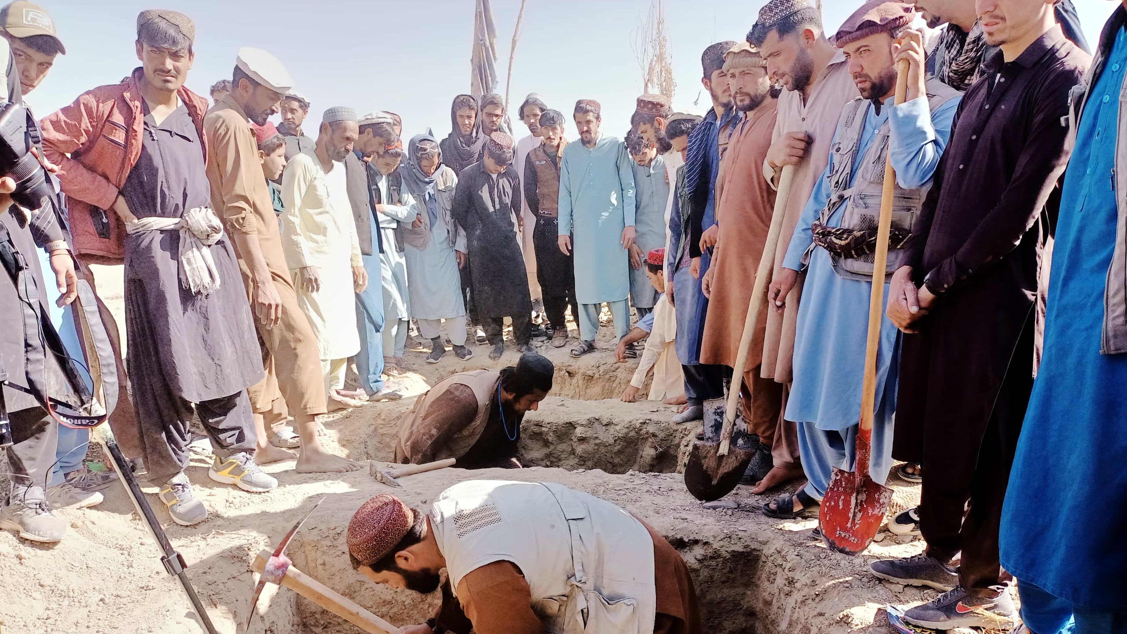 Locals dig graves for people killed in a cross-border airstrike by the Pakistani army in Afghanistan's eastern Paktika province, Saturday, Oct. 18, 2025. (AP Photo/Shafiqullah Mashaal)