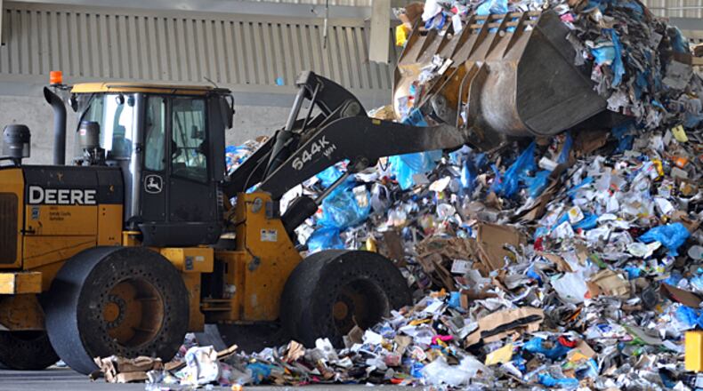 September 12, 2012 DECATUR Loaders move recyclables around the processing area at the Dekalb County Central Transfer Station Wednesday, September 12, 2012. DeKalb County is poised to lift the fee for residents to recycle materials, a move it hopes will encourage more people to set aside their glass, paper and other items and also free up more space in the county-owned landfill. By forgoing $30 for the bin and bags, the county then hopes to save money in the long-run. Will look at costs in other counties. KENT D. JOHNSON / KDJOHNSON@AJC.COM