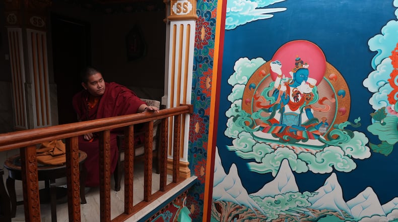U.S.-born Buddhist lama Jalue Dorje pauses outside of his hotel room before he walks to nearby Shechen Monastery for a series of rituals and teachings in Kathmandu, Nepal, on Monday, April 6, 2026. (AP Photo/Luis Andres Henao)