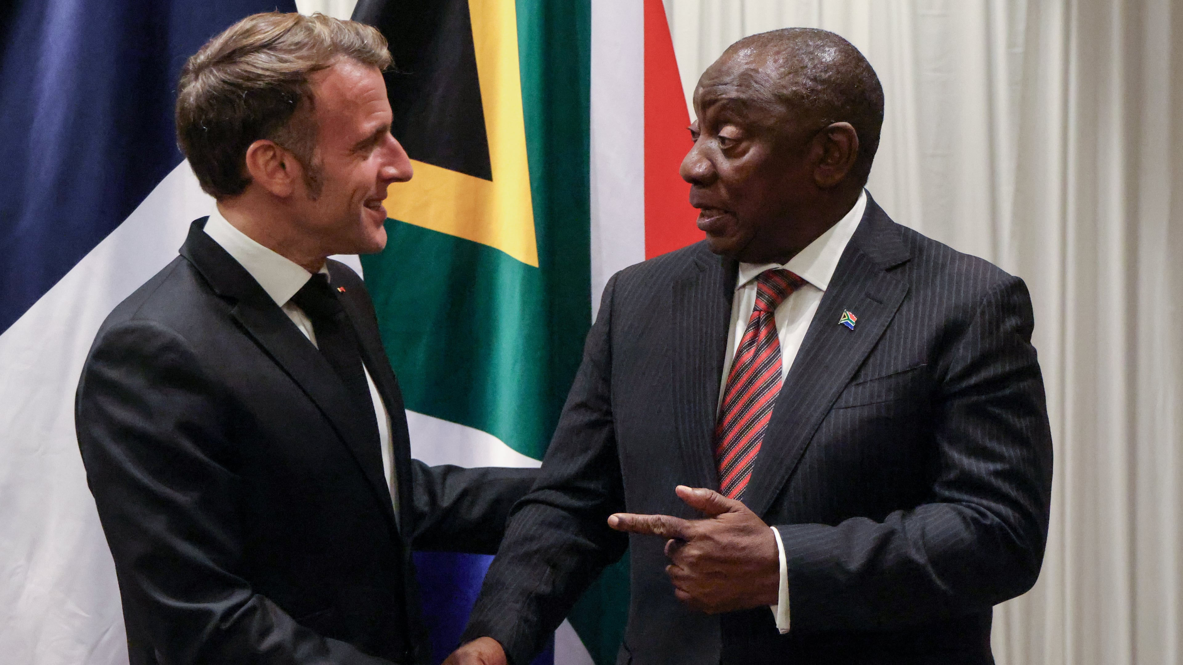 France's President Emmanuel Macron, left, shakes hands with South Africa's President Cyril Ramaphosa during their bilateral meeting at the Sandton Convention Centre in Sandton, South Africa, Friday Nov. 21, 2025, ahead of the G20 leaders' Summit. (Ludovic Marin/Pool Photo via AP)