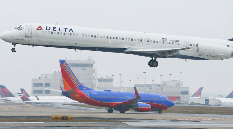 LEDE PHOTO - January 14, 2015 Hartsfield-Jackson International Airport: A Delta jet takes off on Wednesday, Jan. 14, 2015. Hartsfield-Jackson International Airport has lost one of its two titles for world's busiest airport, with Chicago O'Hare taking the title for the most flights, according to year-end data from Flight Aware. Atlanta still carries millions more passengers, but for many years it held both titles. The decline in takeoffs and landings in Atlanta came as Delta Airlines retires regional jets and replaces them with larger planes, while Southwest Airlines cut back on AirTran flights here. JOHN SPINK / JSPINK@AJC.COM
