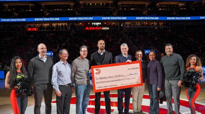 The Atlanta Hawks top last year’s donation with over $160,000 raised to support prostate cancer research. From left to right: Dr. Hadyn Kissick, Assistant Professor, Emory University School of Medicine, Jonathan Simons, President and CEO, Prostate Cancer Foundation, Clark Howard, Consumer Expert and Board Member, Prostate Cancer Foundation, David Lee, Executive Director of The Atlanta Hawks Foundation and Executive Director of External Affairs, Atlanta Hawks, Tony Ressler,Principle Owner, Atlanta Hawks and State farm Arena, Dr. Martin Sanda and Dr. Karen Godette, Emory Winship Cancer Institute, and Hugh Smith, prostate cancer survivor and patient, Emory Winship Institute
