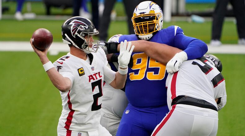 Atlanta Falcons' offensive line protects quarterback Matt Ryan (2) from the pressure by Los Angeles Chargers defensive tackle Linval Joseph (95) during the first half  Sunday, Dec. 13, 2020, in Inglewood, Calif. (Jae C. Hong/AP)