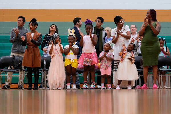 Parishioners stand to worship with Pastor Cory Bowman at River Church Cincinnati's Easter worship service in the Hays Porter Elementary School gym, Sunday, April 20, 2025, in Cincinnati. Cory . (AP Photo/Carolyn Kaster)