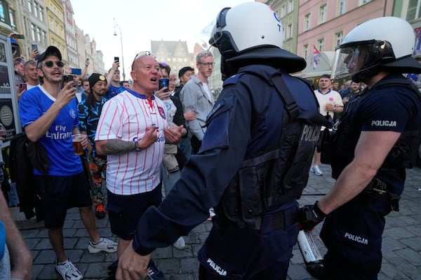 Riot police confront Chelsea fans ahead of the Europa Conference League final soccer match between Real Betis and Chelsea in Wroclaw, Poland, Tuesday, May 27, 2025. (AP Photo/ Czarek Sokolowski)