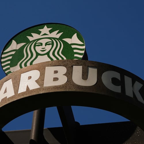 FILE - A Starbucks sign is seen outside the coffee company's global corporate headquarters, May 11, 2026, in Seattle. (AP Photo/Lindsey Wasson, File)