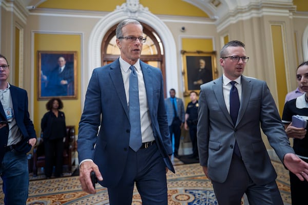 Senate Majority Leader John Thune, R-S.D., rushes from the chamber to his office as he struggles with Republicans opposed to President Donald Trump's signature bill of big tax breaks and spending cuts, at the Capitol in Washington, Tuesday, July 1, 2025. (AP Photo/J. Scott Applewhite)