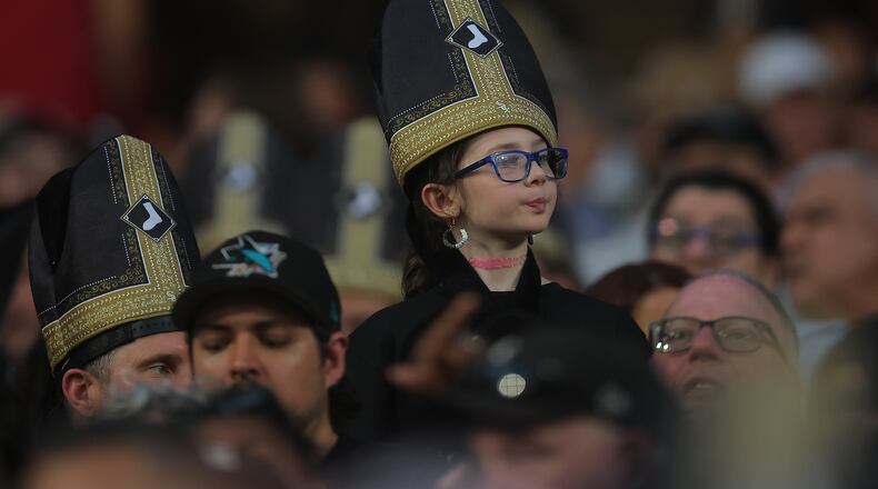 A fan wears a promotional pope hat during a baseball game between the Cincinnati Reds and Chicago White Sox, Tuesday, Aug. 11, 2026, in Chicago. (AP Photo/Melissa Tamez)