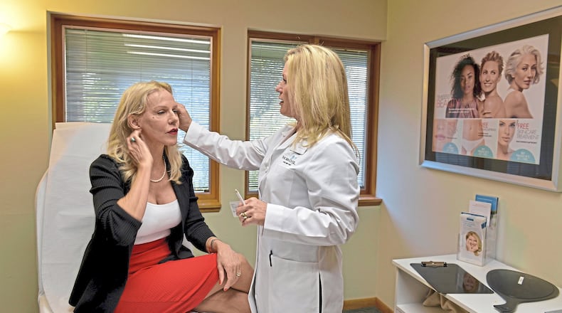 Lela Covey discusses the treatment she will be receiving with Debbie Thompson, RN, during an appointment at the Skin Center Med Spa on Aug. 2, 2017 in Mt. Lebanon, Pa. (Pam Panchak/Pittsburgh Post-Gazette/TNS)