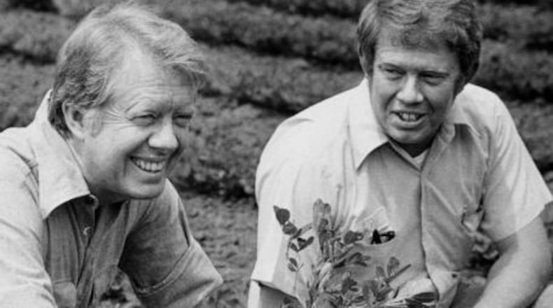 Jimmy Carter, left, and brother Billy talk in 1976 in their hometown of Plains, Ga.