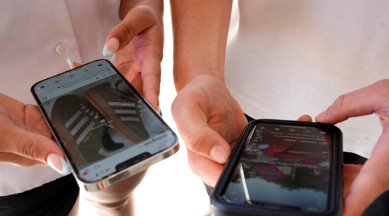 FILE - Young people use their phones to view social media in Sydney, Nov. 8, 2024. (AP Photo/Rick Rycroft, File)