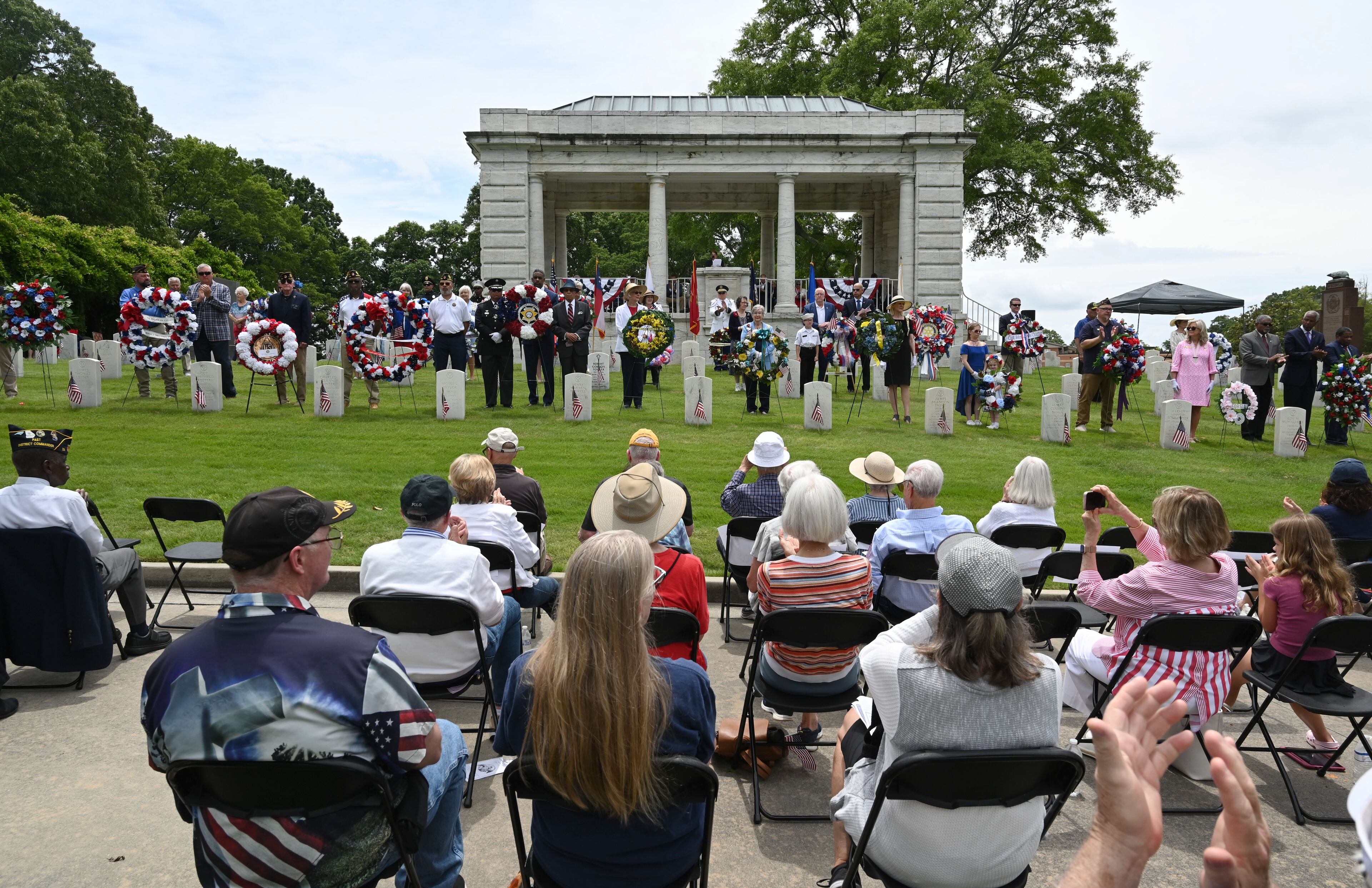 Marietta High School Air Force JROTC members and Memorial Wreath Presenters pose as they present the floral wreaths during the Memorial Day ceremony at Marietta National Cemetery, Monday, May 26, 2025, in Marietta. (Hyosub Shin / AJC)