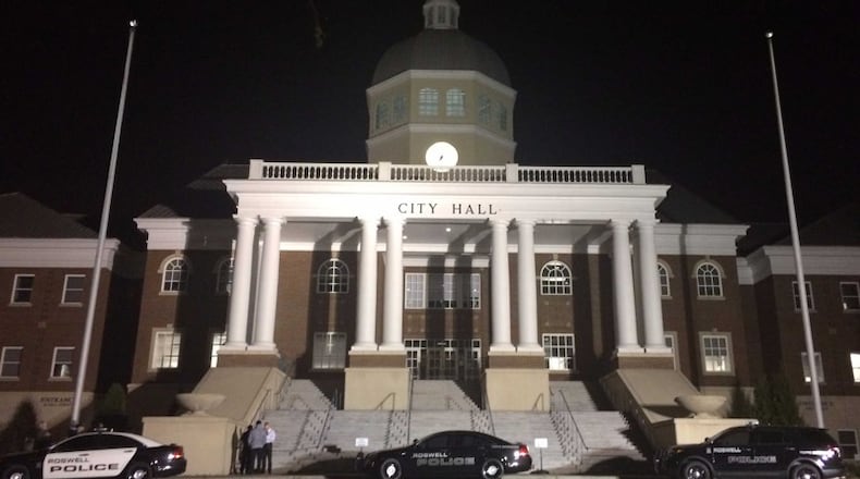 Roswell Police vehicles were parked in front of city hall before the Monday evening meeting.