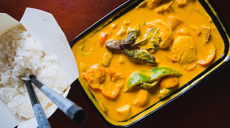 The Mystic Claypot from Top Spice includes scallops, shrimp and squid in a creamy curry sauce. Henri Hollis/henri.hollis@ajc.com