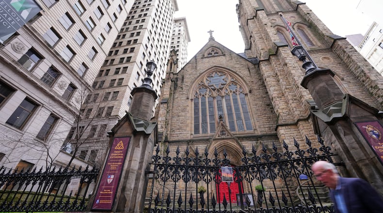 A man walks past Trinity Episcopal Cathedral in downtown Pittsburgh, Wednesday, March 11, 2026. (AP Photo/Gene J. Puskar)