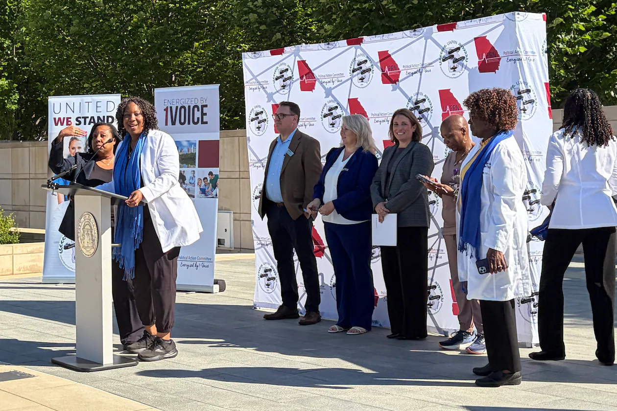 Advanced practice registered nurses gather at Liberty Plaza near the state Capitol on Thursday to announce their concerns about a recent position statement released by the Georgia Composite Medical Board. (Carrie Teegardin/AJC)