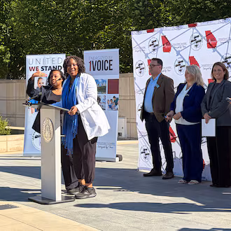 Advanced practice registered nurses gather at Liberty Plaza near the state Capitol on Thursday to announce their concerns about a recent position statement released by the Georgia Composite Medical Board. (Carrie Teegardin/AJC)