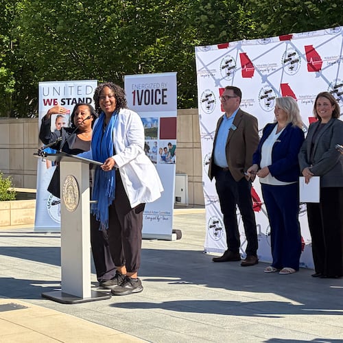Advanced practice registered nurses gather at Liberty Plaza near the state Capitol on Thursday to announce their concerns about a recent position statement released by the Georgia Composite Medical Board. (Carrie Teegardin/AJC)