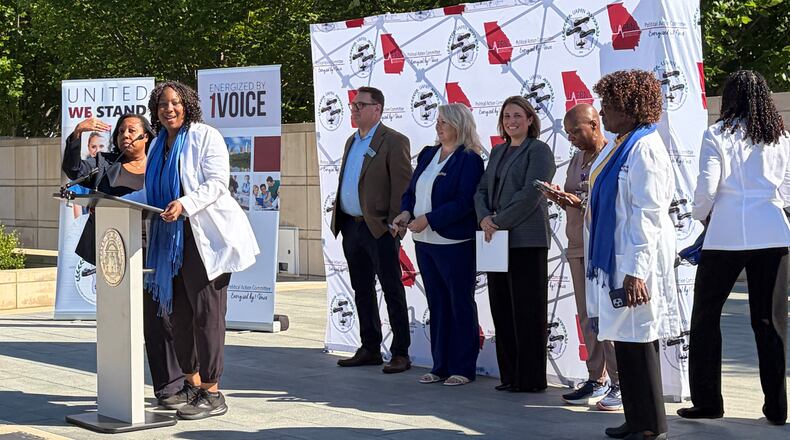 Advanced practice registered nurses gather at Liberty Plaza near the state Capitol on Thursday to announce their concerns about a recent position statement released by the Georgia Composite Medical Board. (Carrie Teegardin/AJC)