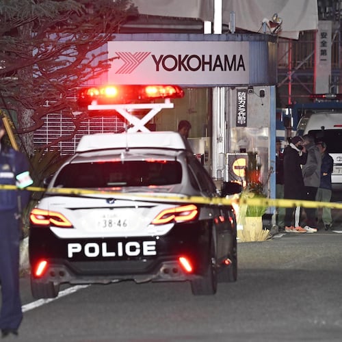 Police officers stand guard at the scene of a stabbing at the Yokohama Rubber Company in Mishima, west of Tokyo, Friday, Dec. 26, 2025. (Yusuke Hashizume/Kyodo News via AP)