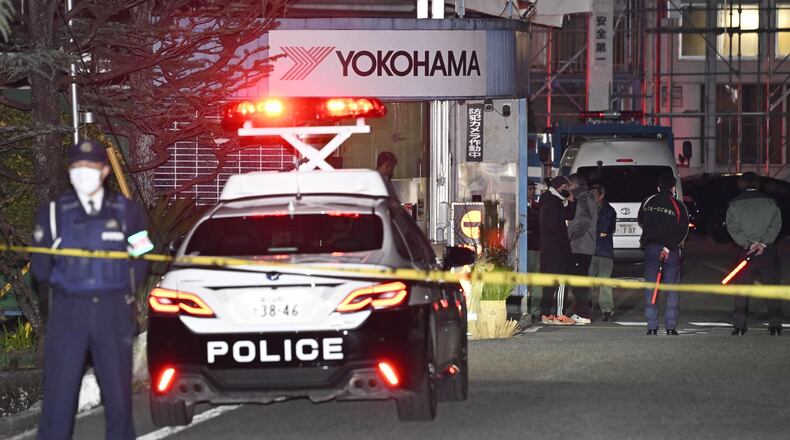 Police officers stand guard at the scene of a stabbing at the Yokohama Rubber Company in Mishima, west of Tokyo, Friday, Dec. 26, 2025. (Yusuke Hashizume/Kyodo News via AP)