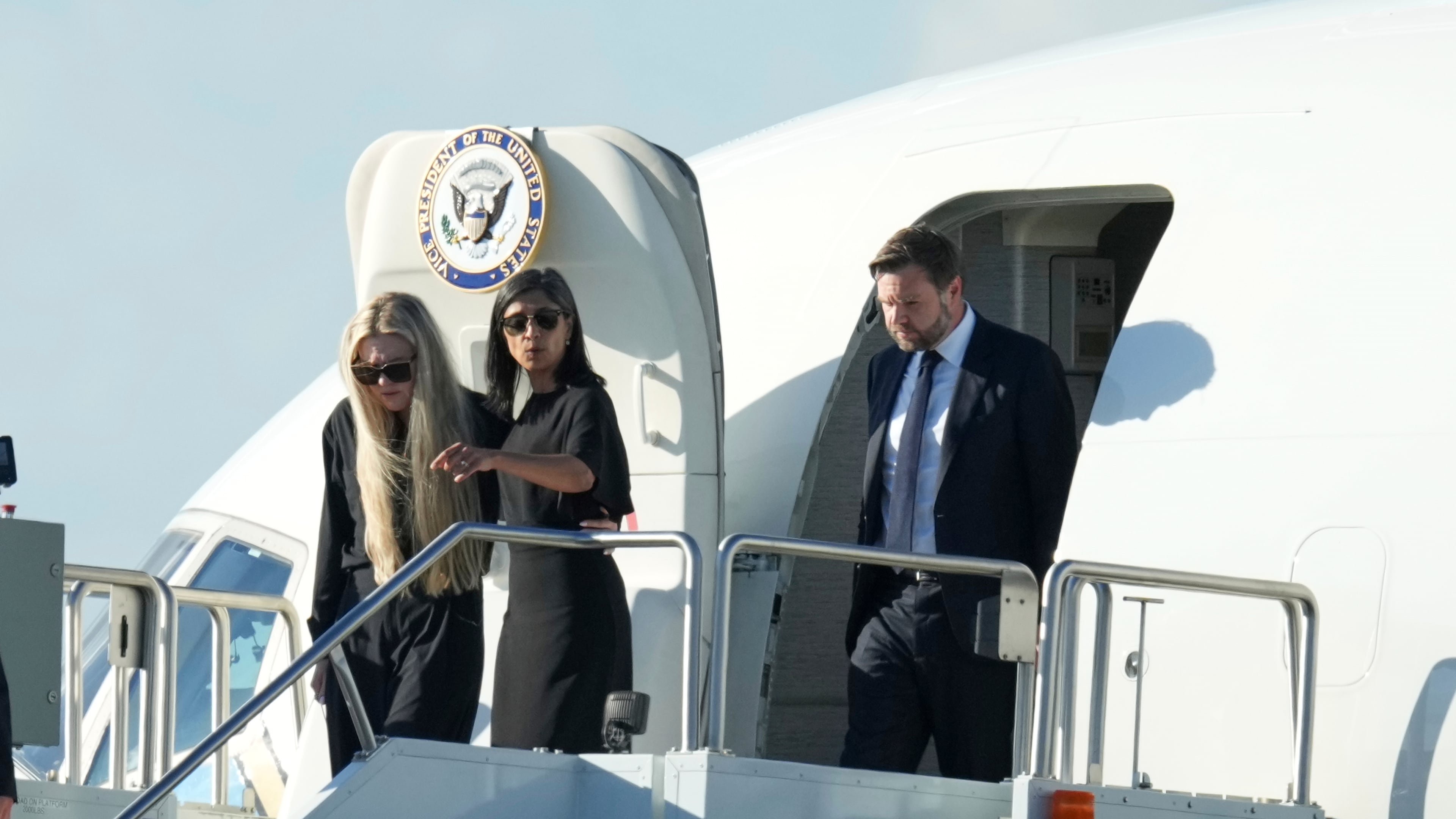 Vice President JD Vance, right, Second Lady Usha Vance, center, and Erika Kirk deplane Air Force Two, carrying the body of Charlie Kirk, the CEO and co-founder of Turning Point USA who was shot and killed, after landing at Phoenix Sky Harbor International Airport, Thursday, Sept. 11, 2025, in Phoenix. (AP Photo/Ross D. Franklin)