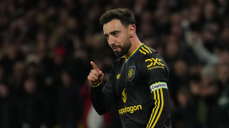 Manchester United's Bruno Fernandes celebrates after scoring during the Premier League soccer match between Wolverhampton Wandere and Manchester United in Wolverhampton, England Monday, Dec. 8, 2025. (AP Photo/Dave Shopland)