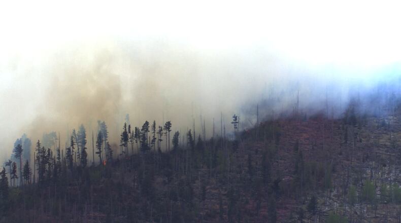 Smoke rises after a small medical plane crashed in a mountain range outside Ruidoso, New Mexico, on Thursday, May 14, 2026. (KOAT via AP)