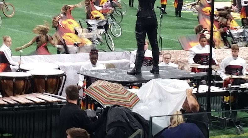 An umbrella provided cover from a roof leak at Mercedes-Benz Stadium on Saturday.