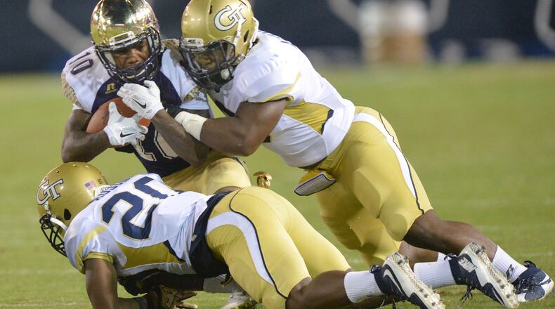 September 3, 2015 Atlanta - Alcorn State Braves wide receiver Marquis Warford (10) gets tackled by Georgia Tech Yellow Jackets defensive back Lawrence Austin (20) and Georgia Tech Yellow Jackets linebacker Victor Alexander (9) in the first half of the Georgia Tech season opener in Bobby Dodd Stadium on Thursday, September 3, 2015. HYOSUB SHIN / HSHIN@AJC.COM