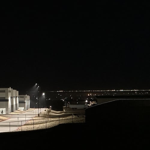 FILE - A massive 826,780-square-foot warehouse sits illuminated Feb. 12, 2026, in the El Paso suburb of Socorro, Texas, that was recently purchased by the U.S. Department of Homeland Security for $122.8 million. (AP Photo/Morgan Lee, file)