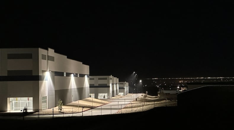 FILE - A massive 826,780-square-foot warehouse sits illuminated Feb. 12, 2026, in the El Paso suburb of Socorro, Texas, that was recently purchased by the U.S. Department of Homeland Security for $122.8 million. (AP Photo/Morgan Lee, file)