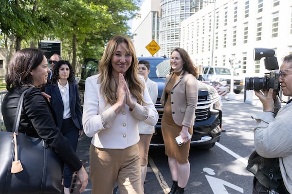 FILE - Nicole Daedone, center, founder and former CEO of OneTaste, center, departs Brooklyn federal court on Tuesday, June 13, 2023 in New York. (AP Photo/Jeenah Moon, File)