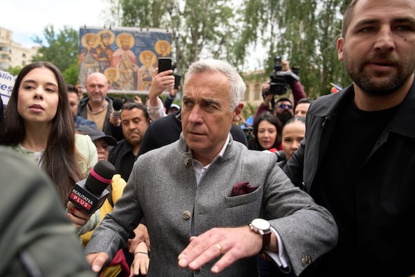 Calin Georgescu, the winner of the first round of last year's annulled election, arrives at a prosecutor's office in Bucharest, Romania, Tuesday, May 27, 2025. (AP Photo/Vadim Ghirda)