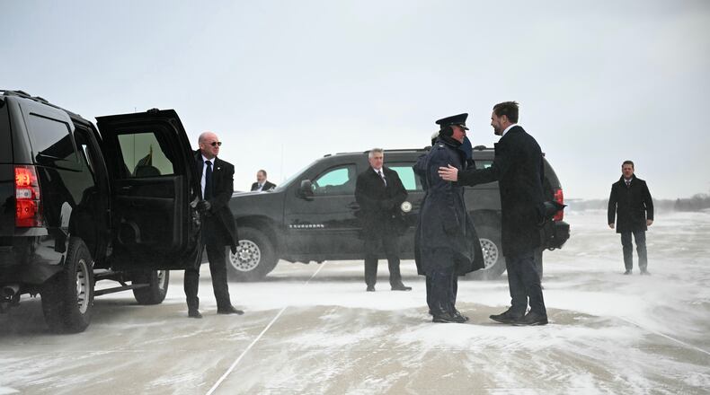 Vice President JD Vance is greeted upon arrival on Air Force Two at Minneapolis'Saint Paul International Airport in Saint Paul, Minn., on Thursday, Jan. 22, 2026. (Jim Watson/Pool Photo via AP)