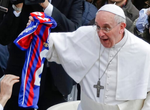 FILE - Pope Francis holds a San Lorenzo's jersey, the Buenos Aires soccer team, handed to him by a faithful at the end of the Easter mass in St. Peter's Square at the Vatican, Sunday, March 31, 2013. (AP Photo/Gregorio Borgia, File)