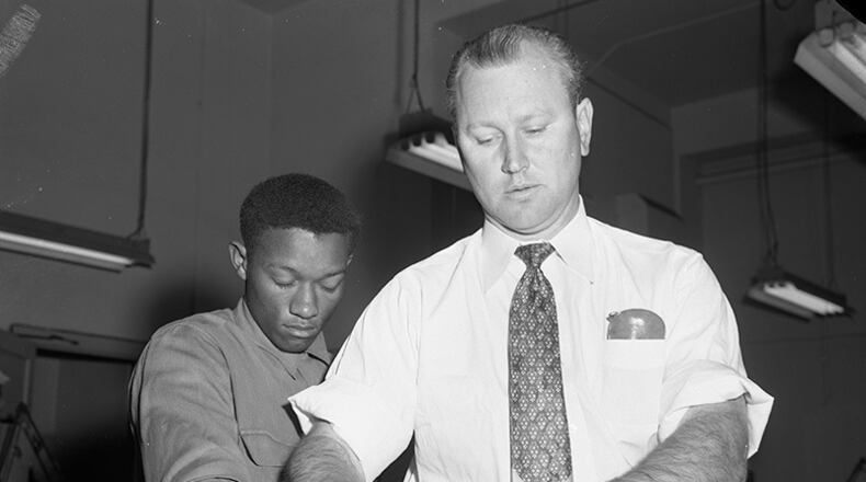 In this photo provided by the Dallas History & Archives Division, Dallas Public Library, Tommy Lee Walker, a Black man from Texas, is fingerprinted after his arrest in January 1954, for the rape and murder of Venice Parker, a white woman. (Dallas History & Archives Division, Dallas Public Library via AP)