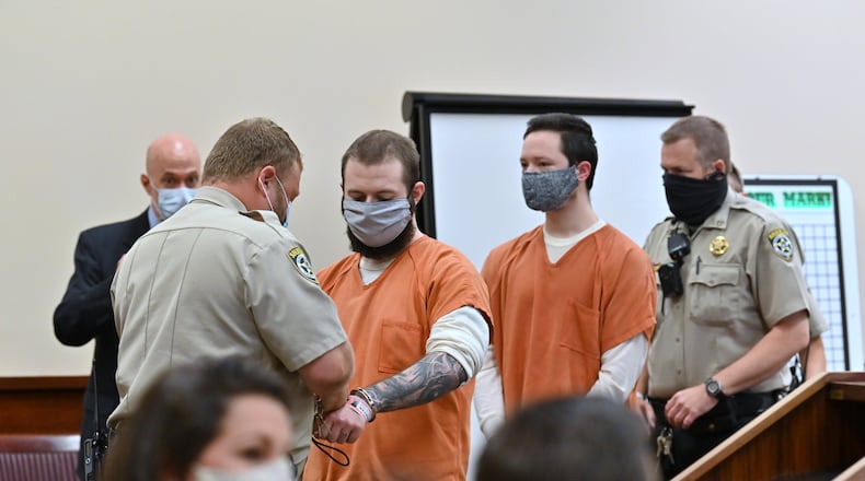 Michael Helterbrand (left) and Jacob Kaderli are escorted in the courtroom for their preliminary hearing before Judge Jack Niedrach at Floyd County Superior Court in Rome on Friday, May 29, 2020. Jacob Kaderli and Michael Helterbrand were in court Friday for a preliminary hearing and another attempt to get bond set for their charges of attempted murder. Luke Lane, Jacob Kaderli and Michael Helterbrand are accused belonging to an international terror group called The Base and of plotting the murder of a Bartow County couple they believed to be involved in anti-racist demonstrations. HYOSUB SHIN / HYOSUB.SHIN@AJC.COM