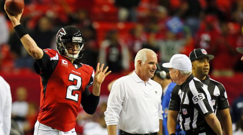 011313 ATLANTA : Head coach Mike Smith makes friendly with the officials while Matt Ryan warms up to play the Seahawks in their NFL divisional playoff game at the Georgia Dome in Atlanta on Sunday, Jan. 13, 2013. CURTIS COMPTON / CCOMPTON@AJC.COM