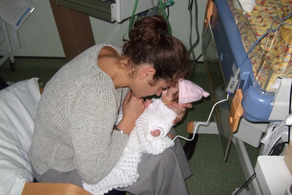 In this photo provided by the Lily Foundation, Liz Curtis, of England, holds her daughter, Lily, who died of a mitochondrial disease in 2006 at 8-months old. (Lily Foundation via AP)