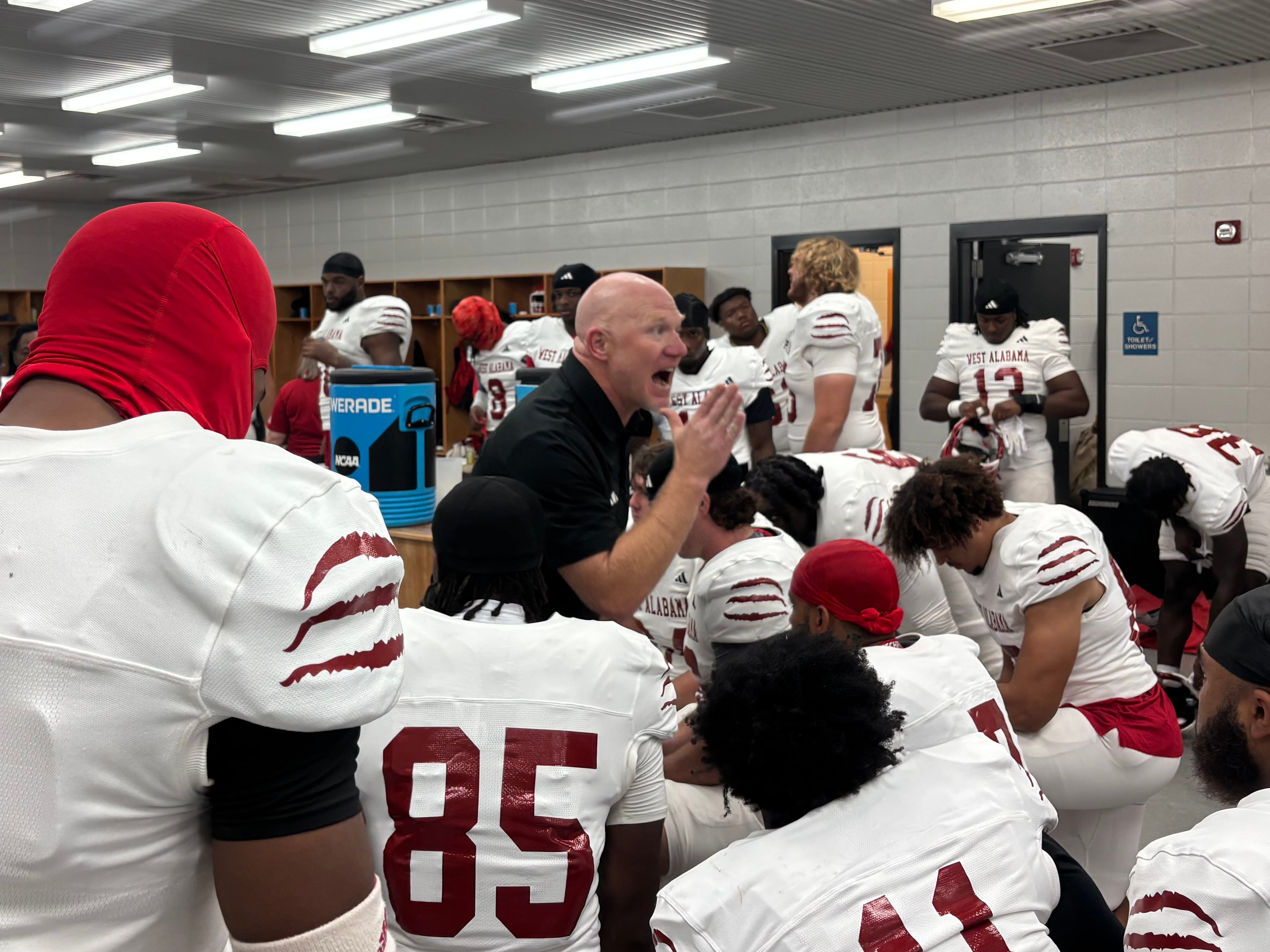 Scott Cochran (center) addresses the West Alabama football team in the locker room before it faces Valdosta State on Nov. 1, 2025. The Tigers lost 45-35 to the Blazers and 33-20 to Northeastern State in the season finale, as West Alabama dropped its final four games to finish 5-4. (Jack Leo/AJC)