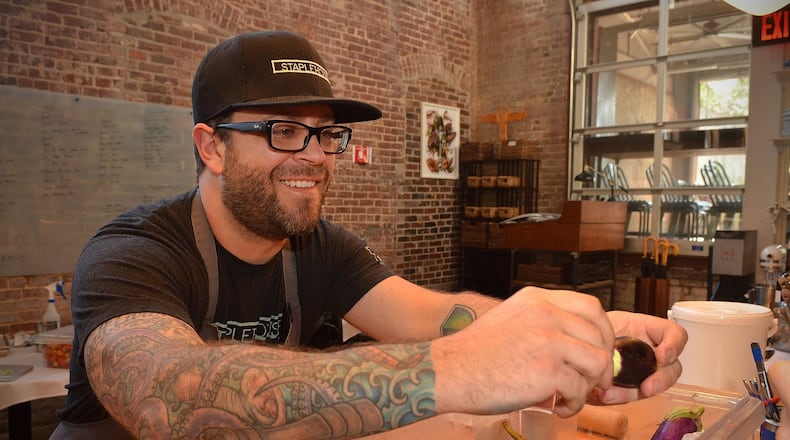 Staplehouse chef Ryan Smith carefully goes through a container of organic eggplant prior to preparation. (Chris Hunt / special)