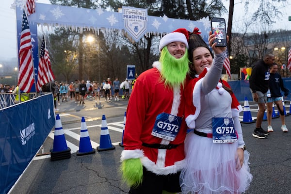 Seth and Allie Dobbs take a selfie at the start line of the 2026 Polar Opposite Peachtree Road Race.