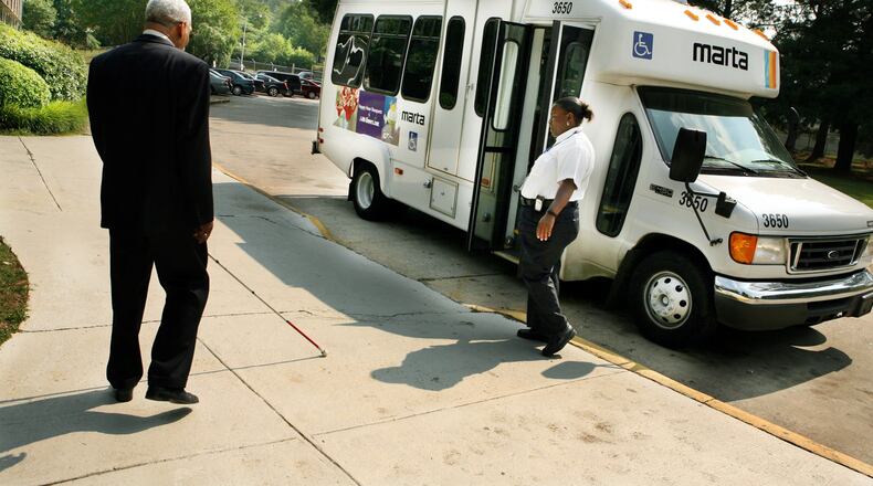 A man who is visually impaired makes his way to a MARTA paratransit vehicle in Atlanta. (JOEY IVANSCO/ AJC staff/ May 2006 file photo)