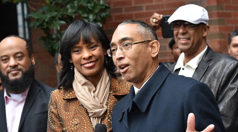 DeKalb County CEO Burrell Ellis speaks to members of the media alongside his wife Philippa outside the county government building on Wednesday. Ellis retook office for the remainder of his dwindling term that expires at the end of the year. HYOSUB SHIN / HSHIN@AJC.COM