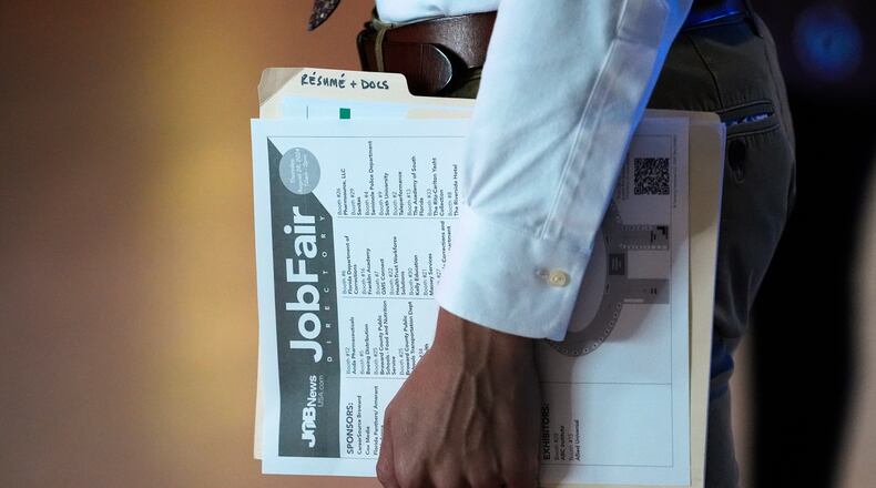 FILE - A person waits in a line for a prospective employer at a job fair, Aug. 29, 2024, in Sunrise, Fla. (AP Photo/Lynne Sladky, File)