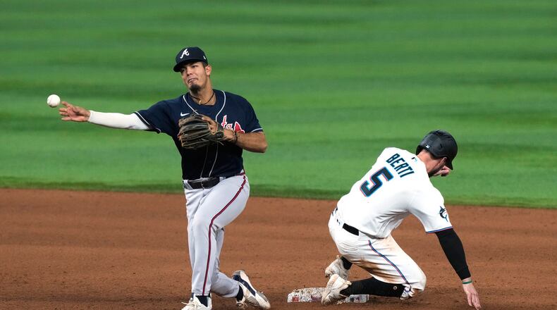 Miami Marlins shortstop Jon Berti (5) is out as Atlanta Braves shortstop Vaughn Grissom throws to first base to complete the double play during the sixth inning of a baseball game, Tuesday, May 2, 2023, in Miami. The Braves deleted the Marlins 6-0. (AP Photo/Marta Lavandier)