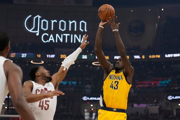 Indiana Pacers forward Pascal Siakam (43) shoots over Cleveland Cavaliers' Donovan Mitchell (45) in the first half during Game 1 in the Eastern Conference semifinals of the NBA basketball playoffs Sunday, May 4, 2025, in Cleveland. (AP Photo/Sue Ogrocki)