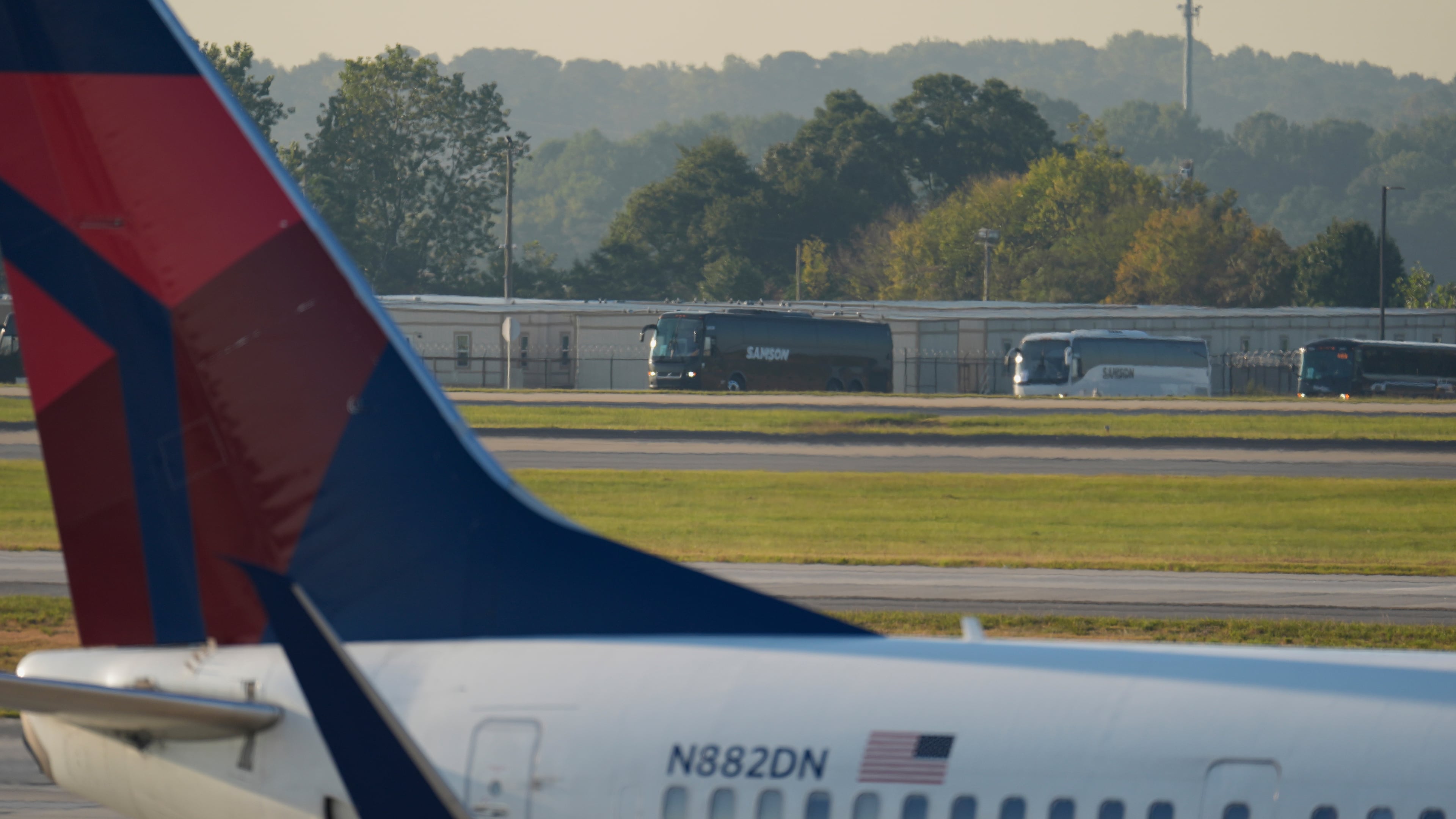 Buses carrying Korean workers detained arrives at Hartsfield-Jackson International Airport in Atlanta, Thursday, Sept. 11, 2025. (AP Photo/George Walker IV)