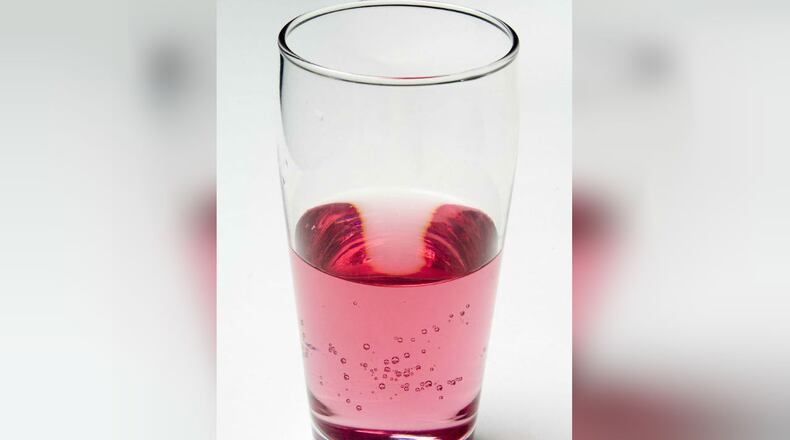 File photo of glass containing pink beverage.